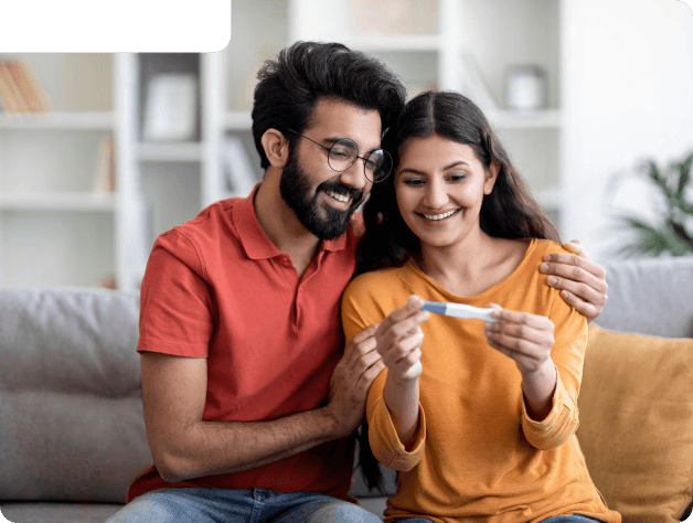 Happy couple reviewing a pregnancy test together